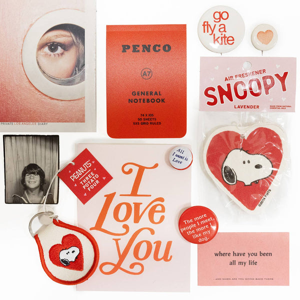 Collection of vintage items including a notebook, stickers, and a card with 'I Love You' text.