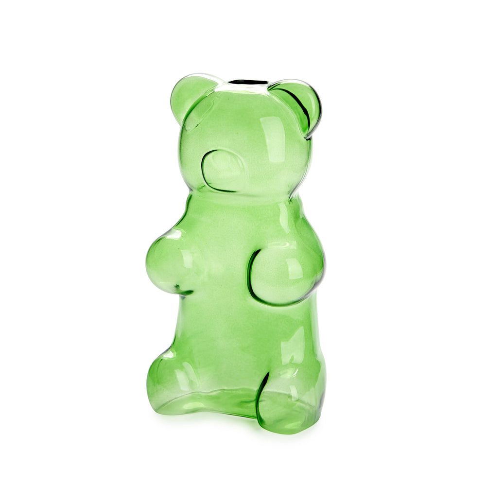 Green gummy bear-shaped vase with a hand holding flowers against a green background
