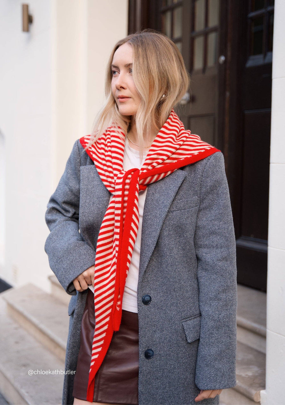 Soft merino wool triangle scarf in red & cream. Versatile, sustainable, and timeless — a best-selling TBCo accessory designed in Edinburgh.