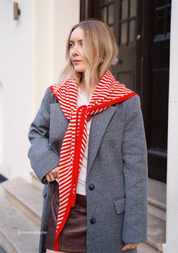 Soft merino wool triangle scarf in red & cream. Versatile, sustainable, and timeless — a best-selling TBCo accessory designed in Edinburgh.