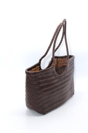 Side view of the hand-woven leather tote bag in chocolate brown.