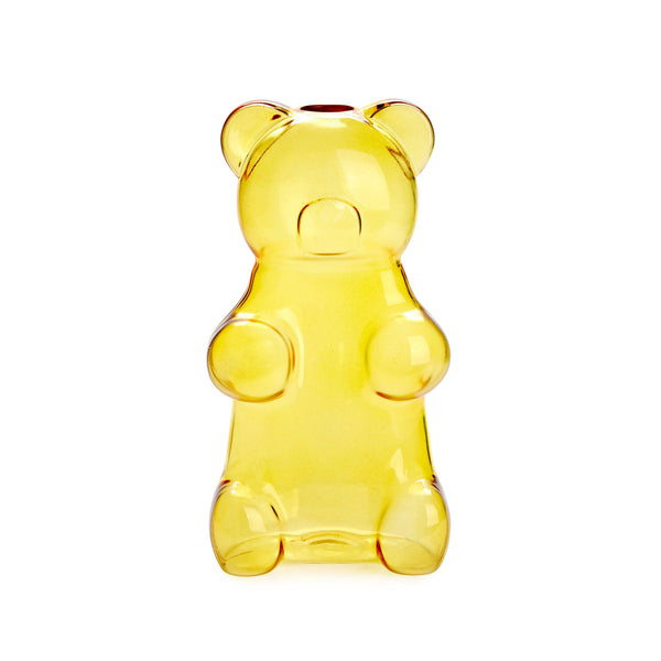Clear yellow gummy bear-shaped bottle on a white background