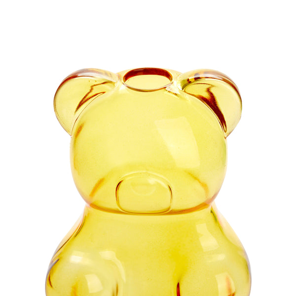 Yellow glass bear-shaped vase on a white background